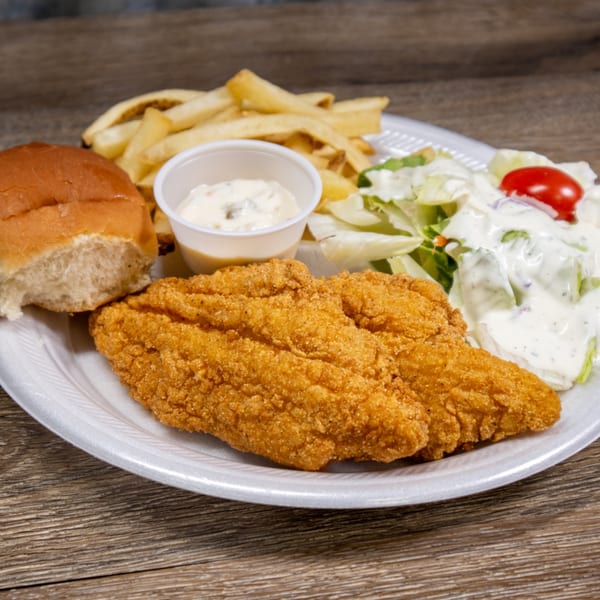 Fried fish fillets, french fries, a side salad with dressing, and a dinner roll on a white plate.
